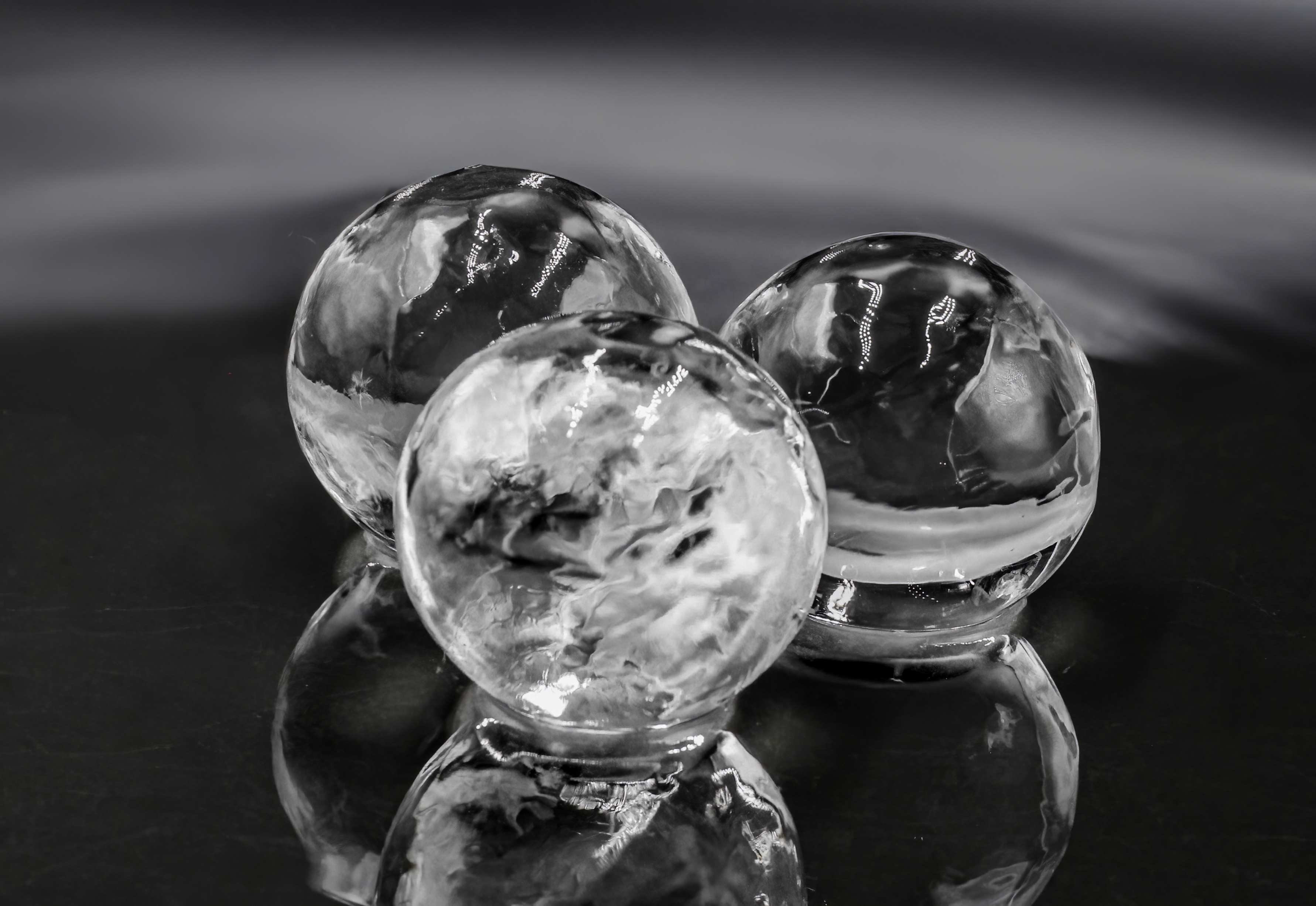 Crystal-clear ice orbs in premium whiskey glass